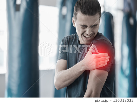 Hand, shoulder pain and the arm of a man in red highlight during a fitness workout. Healthcare, medical and emergency with a male athlete holding his joint after an accident or injury in the gym Hand, shoulder pain and the arm of a man in red highlight during a fitness workout. Healthcare, medical and emergency with a male athlete holding his joint after an accident or injury in the gym 136318033