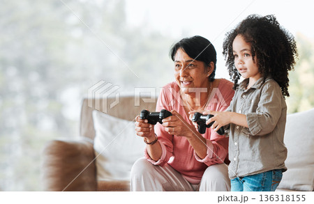 Grandma, child and gaming in home, controller and happy together with bonding, competition and love in lounge. Senior woman, young kid and playing with video game, esports and mockup in family house Grandma, child and gaming in home, controller and happy together with bonding, competition and love in lounge. Senior woman, young kid and playing with video game, esports and mockup in family house 136318155
