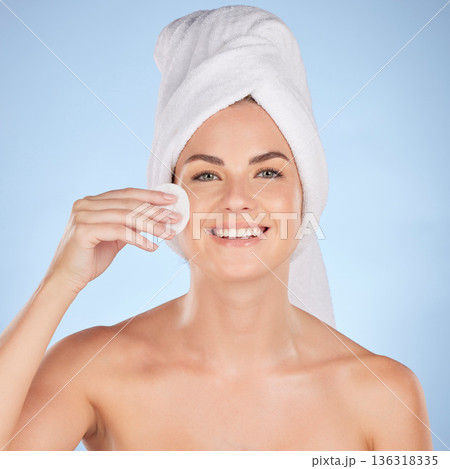 Bathroom, studio portrait and happy woman with cotton pad for skincare cleaning, self care or foundation. Beauty, face or person with hygiene, wellness and makeup removal product on blue background Bathroom, studio portrait and happy woman with cotton pad for skincare cleaning, self care or foundation. Beauty, face or person with hygiene, wellness and makeup removal product on blue background 136318335
