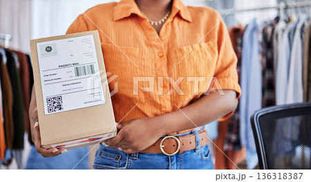 Hands, designer or woman with box for delivery, shipping or package with logistics in ecommerce in office. Closeup, fashion or business owner with clothes stock or store order for courier service Hands, designer or woman with box for delivery, shipping or package with logistics in ecommerce in office. Closeup, fashion or business owner with clothes stock or store order for courier service 136318387