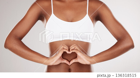 Body, heart and stomach of a woman for health and wellness on a white studio background. Fitness, gut and diet of aesthetic female model for weight loss, balance or digestion with hands or love emoji 136318515