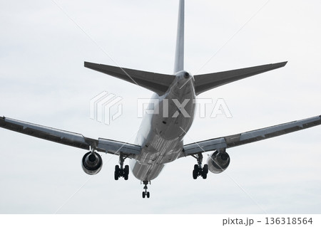 A huge passenger plane is landing in airport of Phuket, Thailand, a bottom view A huge passenger plane is landing in airport of Phuket, Thailand, a bottom view 136318564