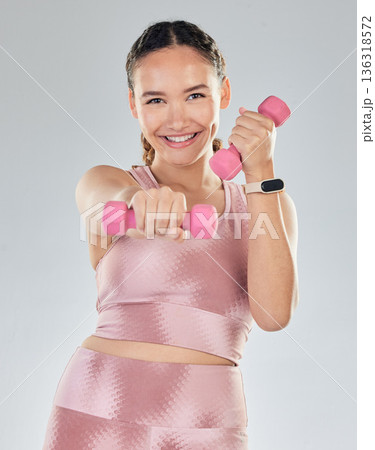 Fitness, portrait and woman with dumbbell isolated on studio white background for health, exercise and gym power. Bodybuilder, face and sports person happy for workout goals and lose weight training 136318572