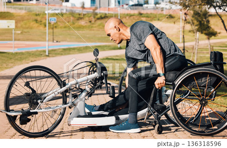Wheelchair, athlete or a man with a disability and bike for handicap race, fitness and recumbent challenge. Exercise, park and a handbike of paraplegic sports person outdoor for cardio and training 136318596