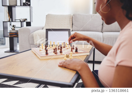 Video call, chess and woman in home with tablet, mockup and screen for gaming connection in lounge. Thinking, internet and chessboard, virtual strategy board game and African girl problem solving. 136318661