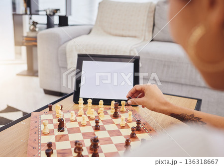 Video call, chess and woman with tablet, mockup and screen in gaming connection in living room. Thinking, internet and chessboard, virtual strategy board game and African girl problem solving in home 136318667