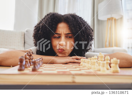 Chess, thinking and portrait of woman with board for strategy, problem solving and challenge at home. Competition, ideas and female person with chessboard in living room ready for playing games Chess, thinking and portrait of woman with board for strategy, problem solving and challenge at home. Competition, ideas and female person with chessboard in living room ready for playing games 136318671