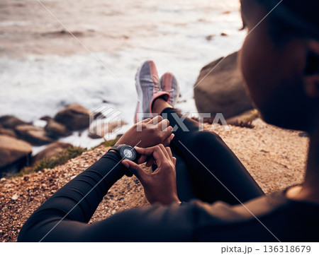 Relax, running and smart watch with hand of woman on rock for check, fitness tracker and heart rate. Workout, exercise and goal with closeup of female runner at beach for monitor, goals and time Relax, running and smart watch with hand of woman on rock for check, fitness tracker and heart rate. Workout, exercise and goal with closeup of female runner at beach for monitor, goals and time 136318679