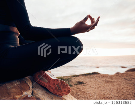 Lotus pose, hands and yoga at the beach, fitness and meditation, spiritual wellness with person in nature. Exercise, zen and yogi on rock outdoor with holistic healing and calm, sea and mindfulness 136318683