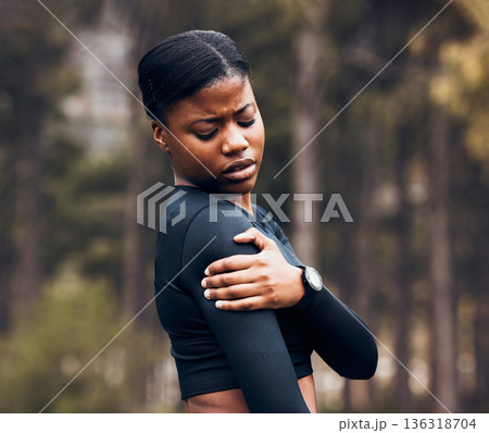 Shoulder, pain and sports woman outdoor for health risk, bruise and hands on wound in park. Fitness, black female athlete and arm injury of muscle, joint problem and first aid for exercise accident 136318704