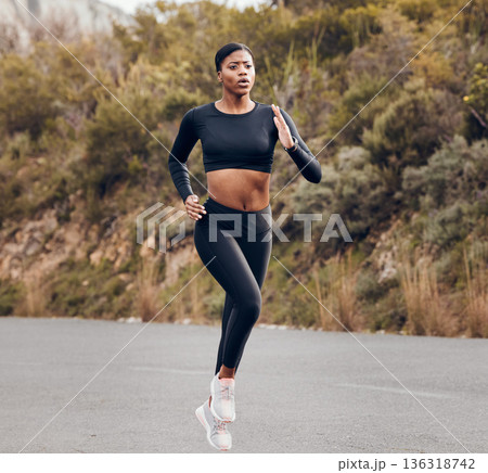 Mountain, running and woman for fitness, exercise and speed training, outdoor challenge and focus on road. Fast professional runner, athlete or african sports person for cardio workout or marathon 136318742