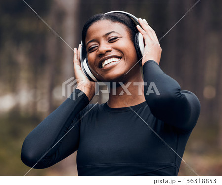 Fitness, black woman listening to music and in woods with headphones happy for workout. Exercise or workout, training or happy and female athlete listen to radio or podcast for motivation in nature Fitness, black woman listening to music and in woods with headphones happy for workout. Exercise or workout, training or happy and female athlete listen to radio or podcast for motivation in nature 136318853