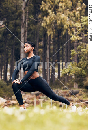 Stretching, fitness and black woman lunge in nature for exercise, training and sports in forest. Hiking, mountain and female person stretch legs for warm up, workout and wellness for performance 136318857