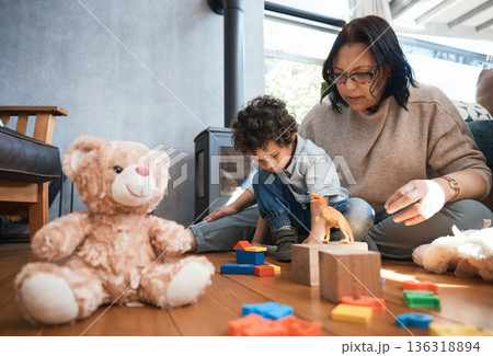 Toys, family or kids with a mother and son playing in the bedroom of their home together for child development. Children, teddy bear or education and a boy learning motor skills with a woman parent Toys, family or kids with a mother and son playing in the bedroom of their home together for child development. Children, teddy bear or education and a boy learning motor skills with a woman parent 136318894