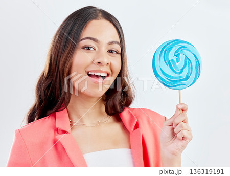 Portrait, smile and woman with a lollipop, candy and promotion against a white studio background. Face, female person and happy model with dessert, treats and sweets with joy, product and aesthetic 136319191