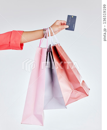 Credit card, studio or hand of woman with shopping bags for retail sale, product offer or discount deal. Financial, customer or girl shopper holding gifts or present on promotion on white background 136319199