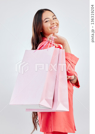 Happy customer, smile or portrait of woman with shopping bag for retail sale, store offer or discount deal. Choice, smiling or girl shopper holding gifts or product on promotion on white background 136319204