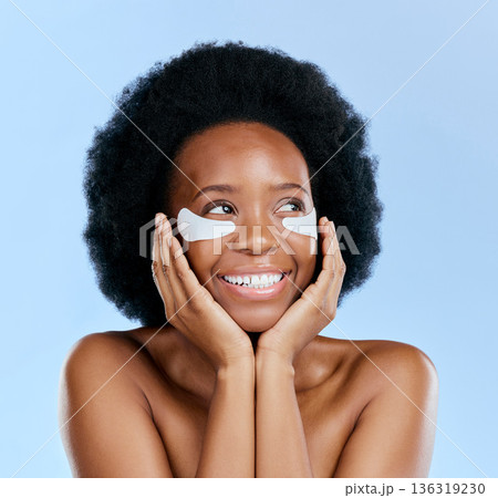 Beauty, skincare and eye mask with black woman in studio for facial, cosmetics and dermatology. Spa, wellness and self care with face of female person on blue background for salon, glow and detox 136319230