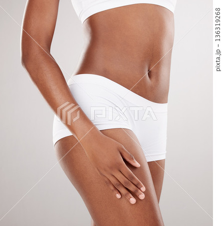 Skin, healthy body and hand on thigh of a person for health and wellness on a white studio background. Fitness, cellulite and skincare of female model on a diet for weight loss, balance or motivation Skin, healthy body and hand on thigh of a person for health and wellness on a white studio background. Fitness, cellulite and skincare of female model on a diet for weight loss, balance or motivation 136319268