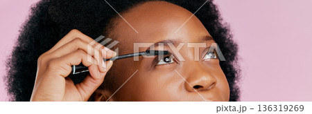 Eyes, mascara and brush, makeup and black woman, beauty and cosmetic product on pink background. Female model, hand and eyelash extension, cosmetology and lashes transformation with glow in studio Eyes, mascara and brush, makeup and black woman, beauty and cosmetic product on pink background. Female model, hand and eyelash extension, cosmetology and lashes transformation with glow in studio 136319269