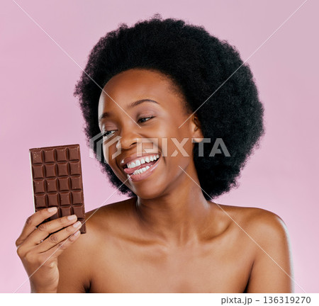 Black woman, chocolate and diet with candy and beauty, health and dessert snack isolated on pink background. Skin, glow and happy female model with cacao sweets, calories and cosmetics in studio Black woman, chocolate and diet with candy and beauty, health and dessert snack isolated on pink background. Skin, glow and happy female model with cacao sweets, calories and cosmetics in studio 136319270