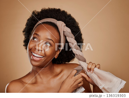 Happy, afro or black woman with headband thinking of change or beauty in studio on brown background. Tie, smile or thoughtful African girl model excited by haircare idea, scarf hairstyle or self love Happy, afro or black woman with headband thinking of change or beauty in studio on brown background. Tie, smile or thoughtful African girl model excited by haircare idea, scarf hairstyle or self love 136319303