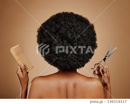 Back, comb and scissors with a black woman in studio on a brown background for a haircut. Salon, afro and haircare with a natural female model at the hairdresser for hairstyling or beauty from behind Back, comb and scissors with a black woman in studio on a brown background for a haircut. Salon, afro and haircare with a natural female model at the hairdresser for hairstyling or beauty from behind 136319317