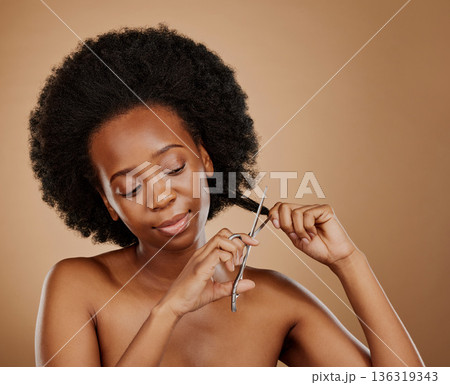Afro haircut, scissors and black woman with beauty problem, salon treatment or breakage. Cosmetics, young and African girl or model with a tool to cut or trim dameged hairstyle on a studio background Afro haircut, scissors and black woman with beauty problem, salon treatment or breakage. Cosmetics, young and African girl or model with a tool to cut or trim dameged hairstyle on a studio background 136319343