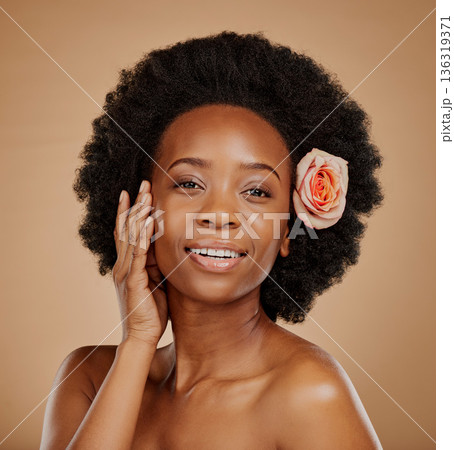 Black woman, face and skincare with rose in studio isolated on a brown background. Portrait, flower and happy African model with natural cosmetics, organic facial treatment and floral beauty plant. 136319371