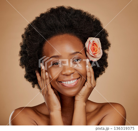 Beauty, flower and portrait of an African woman in studio with skincare, natural and face routine. Cosmetic, health and female model with floral rose in hair for facial treatment on brown background Beauty, flower and portrait of an African woman in studio with skincare, natural and face routine. Cosmetic, health and female model with floral rose in hair for facial treatment on brown background 136319375