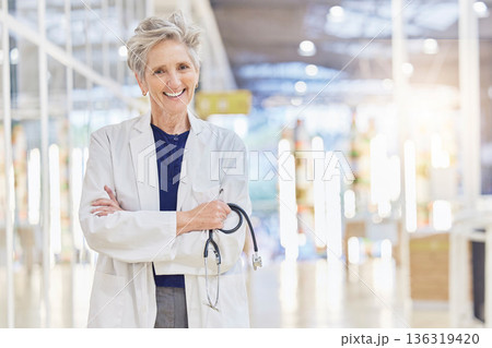 Doctor, portrait and senior woman with arms crossed, happy and bokeh in hospital. Elderly surgeon, face and confident medical professional, expert or healthcare worker with stethoscope for cardiology Doctor, portrait and senior woman with arms crossed, happy and bokeh in hospital. Elderly surgeon, face and confident medical professional, expert or healthcare worker with stethoscope for cardiology 136319420