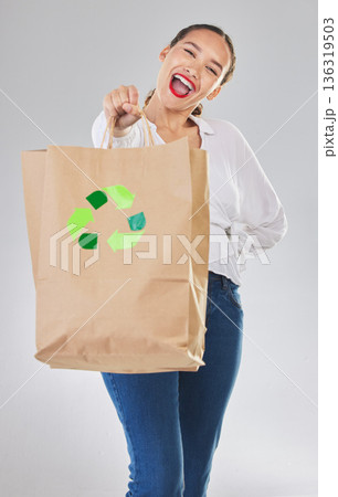 Recycling, environment and happy woman with bag, carbon footprint and sustainability with shopping on white background. Environmental, retail and eco friendly, female person excited in studio Recycling, environment and happy woman with bag, carbon footprint and sustainability with shopping on white background. Environmental, retail and eco friendly, female person excited in studio 136319503