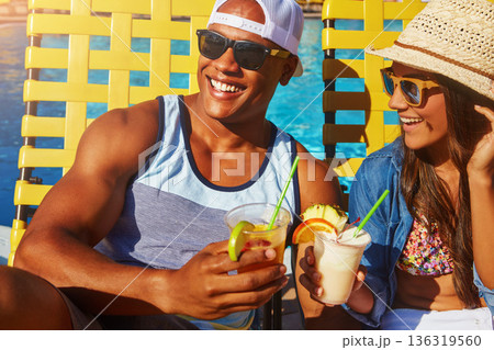 Cocktail, couple and swimming pool with sunglasses for tanning on holiday with happiness at resort. Summer, poolside with man or woman with drinks or smile to relax and enjoy at hotel with alcohol. 136319560