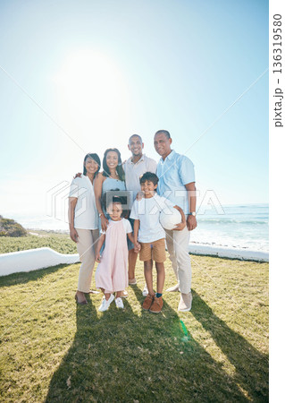 Family, portrait and outdoors with happiness in nature with ball in mockup space with children. Happy, parents and generations are standing in garden or summer for bond or quality time together. Family, portrait and outdoors with happiness in nature with ball in mockup space with children. Happy, parents and generations are standing in garden or summer for bond or quality time together. 136319580