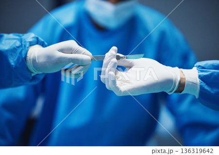Hospital knife, surgery and doctors hands in theatre for medical support, teamwork and emergency healthcare. Doctor, nurse and surgeon team work, giving tools and helping in operating room zoom Hospital knife, surgery and doctors hands in theatre for medical support, teamwork and emergency healthcare. Doctor, nurse and surgeon team work, giving tools and helping in operating room zoom 136319642