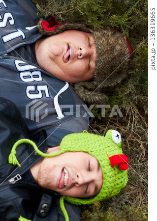Hangover, drunk and men sleeping on grass with tongue out in top view after party. Outdoor, alcoholism and tired friends on ground together with plus size person resting in a park in the morning. Hangover, drunk and men sleeping on grass with tongue out in top view after party. Outdoor, alcoholism and tired friends on ground together with plus size person resting in a park in the morning. 136319665