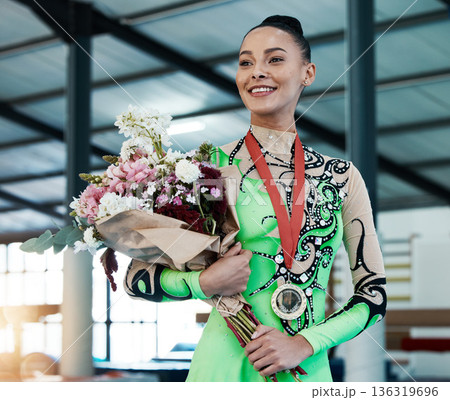 Woman, gymnastics and winner, medal and flower bouquet, happy with celebration and winning competition. Prize, reward and bonus, female champion on podium with gymnast and athlete smile with gift 136319696