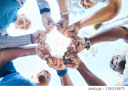Fist bump, fitness and group of people for teamwork, collaboration and community, team building and support. Mission, workout goals and hands, power and solidarity sign of person outdoor from below Fist bump, fitness and group of people for teamwork, collaboration and community, team building and support. Mission, workout goals and hands, power and solidarity sign of person outdoor from below 136319875