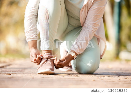Fitness, feet and person tying laces for exercise, workout and outdoor training ready for wellness and health. Sneakers, shoes and woman or runner prepare footwear for running, sports and marathon Fitness, feet and person tying laces for exercise, workout and outdoor training ready for wellness and health. Sneakers, shoes and woman or runner prepare footwear for running, sports and marathon 136319883