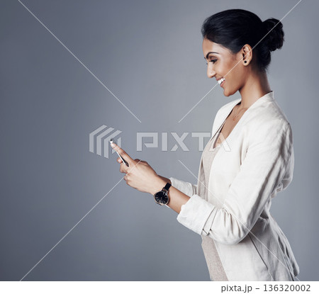 Business, employee and woman with a cellphone, connection and social media on a grey studio background. Female person, advertising agent and model with a smartphone, website information and contact Business, employee and woman with a cellphone, connection and social media on a grey studio background. Female person, advertising agent and model with a smartphone, website information and contact 136320002