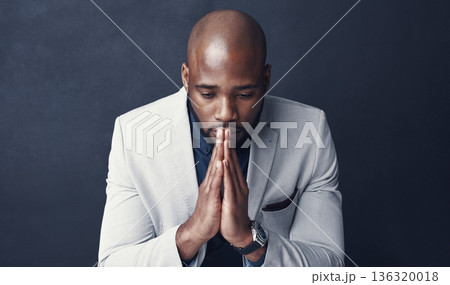 Praying, thinking and business man with faith for career, job or opportunity, asking god for help and support. Corporate african person with prayer sign, sad or hope isolated on dark gray background Praying, thinking and business man with faith for career, job or opportunity, asking god for help and support. Corporate african person with prayer sign, sad or hope isolated on dark gray background 136320018