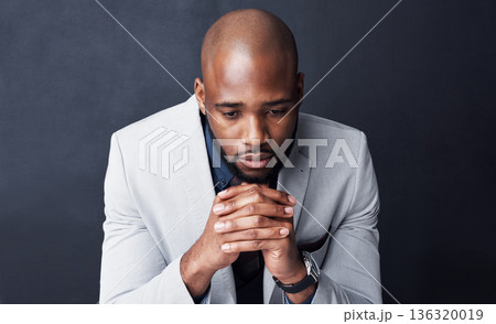 Praying, sign and business man sad for career, job or work opportunity and god help or support. Corporate african person with depression and prayer hands for religion isolated on dark wall background Praying, sign and business man sad for career, job or work opportunity and god help or support. Corporate african person with depression and prayer hands for religion isolated on dark wall background 136320019