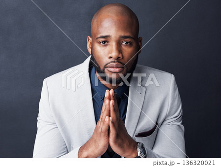 Praying, portrait and business man with faith for career, job or opportunity, asking god for help and support. Corporate african person in prayer sign, emoji and hope isolated on dark wall background 136320021