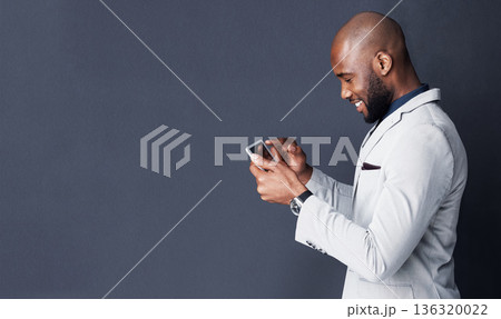 Tablet, search and business man isolated on a dark background with mockup for news, information or social media. Professional african person typing, reading or scroll on digital tech on a banner wall Tablet, search and business man isolated on a dark background with mockup for news, information or social media. Professional african person typing, reading or scroll on digital tech on a banner wall 136320022