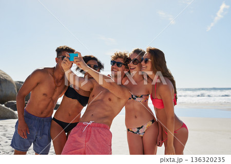 Selfie, beach and group of friends for summer, holiday and vacation in bikini, social media post and content creation. Happy young people or men and women in profile picture or digital memory at sea 136320235