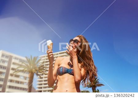 Woman, ice cream and lick fingers outdoor with blue sky mockup space on summer vacation alone. Gelato, food and person in bikini with dessert, vanilla and eating snack on holiday, travel or freedom. 136320242