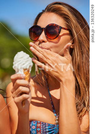 Ice cream, woman and lick finger outdoor on summer vacation alone. Gelato, food and person in bikini with dessert, eating vanilla sweets and enjoying delicious snack on holiday, freedom and travel. Ice cream, woman and lick finger outdoor on summer vacation alone. Gelato, food and person in bikini with dessert, eating vanilla sweets and enjoying delicious snack on holiday, freedom and travel. 136320249