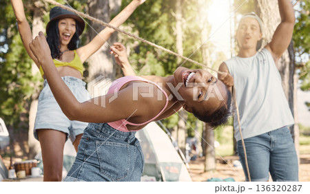 Happy, portrait and friends playing limbo for freedom, holiday games and camping activity. Smile, summer and a black woman having fun with a rope and social people while on vacation in a forest 136320287