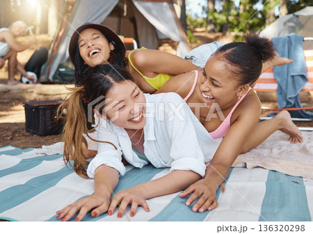 Group, women friends and woods for camping, funny and laying on blanket with joke, diversity and vacation. Young girl students, comic laughing and playing on ground in summer, sunshine and forrest Group, women friends and woods for camping, funny and laying on blanket with joke, diversity and vacation. Young girl students, comic laughing and playing on ground in summer, sunshine and forrest 136320298