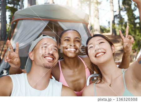 Smile, peace sign and selfie of friends camping in forest, woods or nature together. Happy, v hand and people taking picture for hiking, social media emoji or group memory outdoor on summer vacation. 136320308